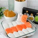 Halloween S'mores Dip with melted chocolate and halloween peep marshmallows