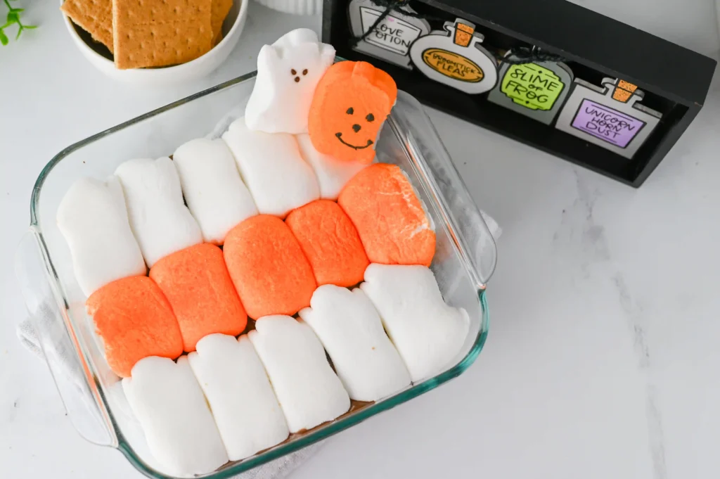 Halloween S'mores Dip with melted chocolate and halloween peep marshmallows