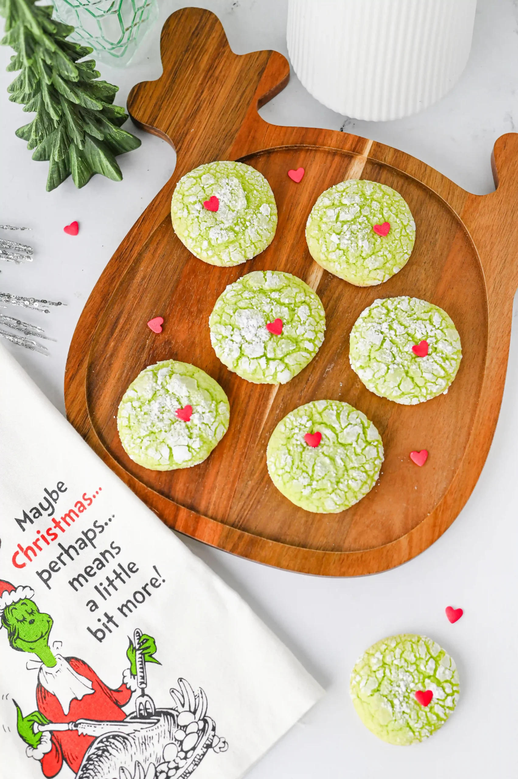 green crinkle cookies with a red heart sprinkle