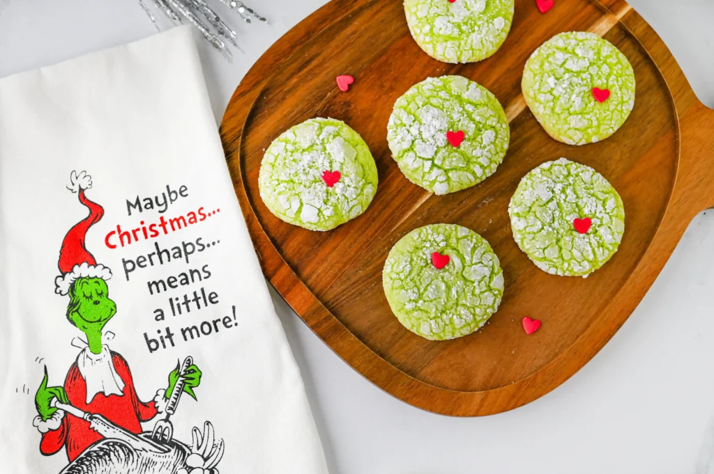 green crinkle cookies with a red heart sprinkle