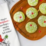 green crinkle cookies with a red heart sprinkle