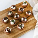 hot cocoa brownie bites with marshmallows and hot fudge on top
