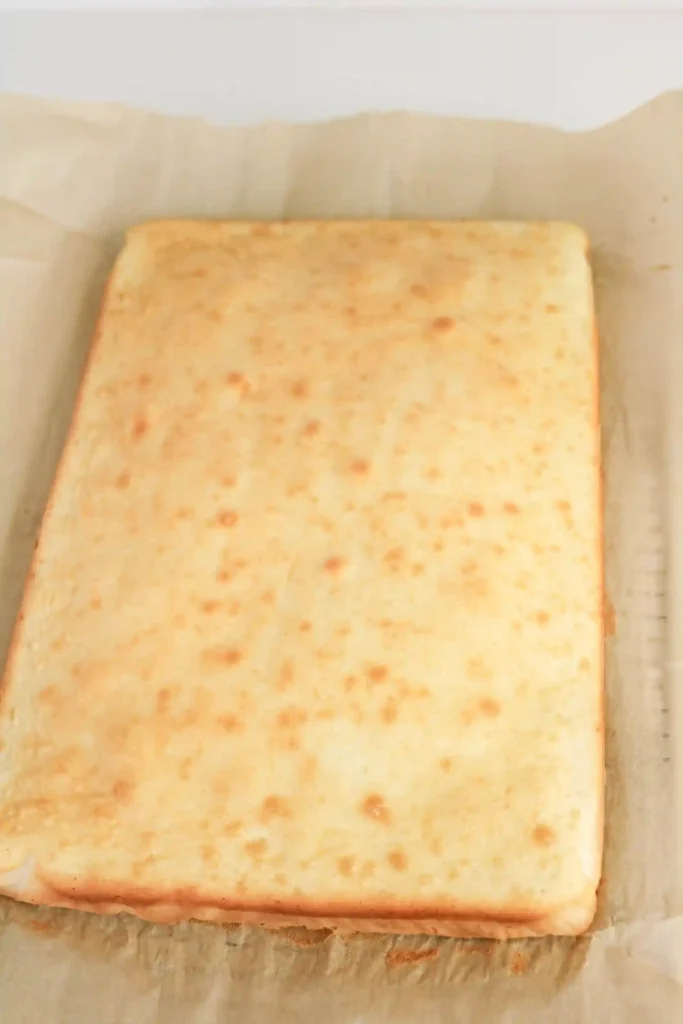 white rectangular cake on parchment paper