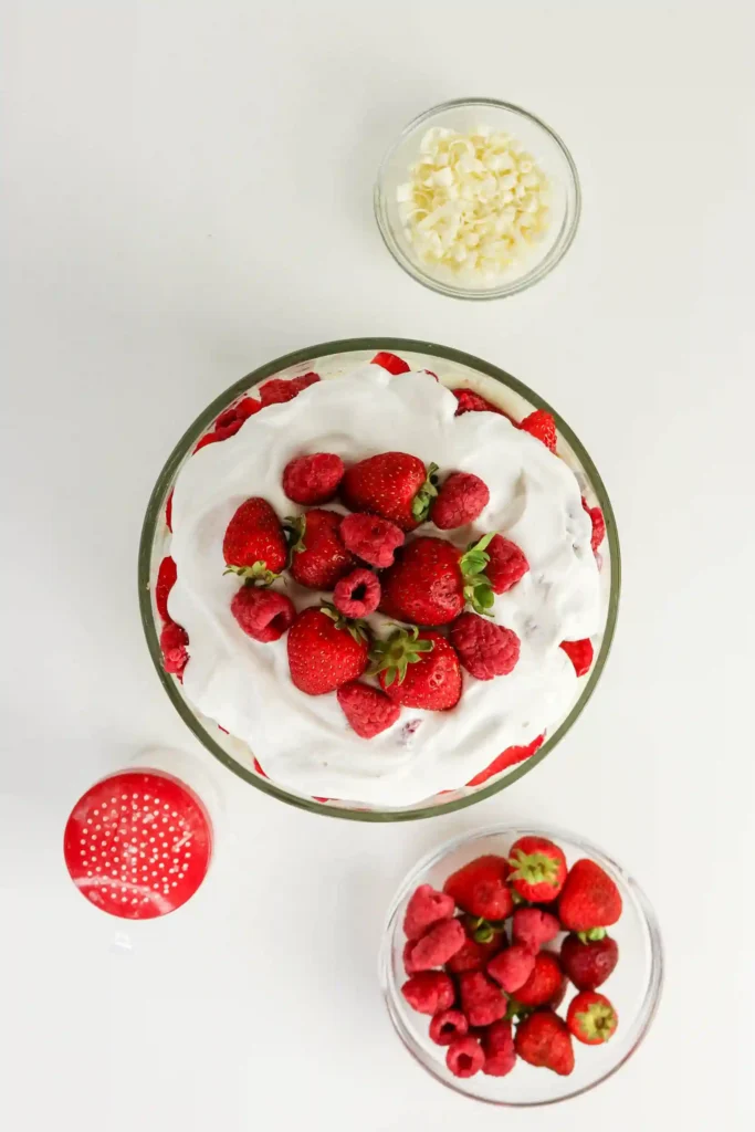 a Christmas trifle with strawberries and whipped cream on top