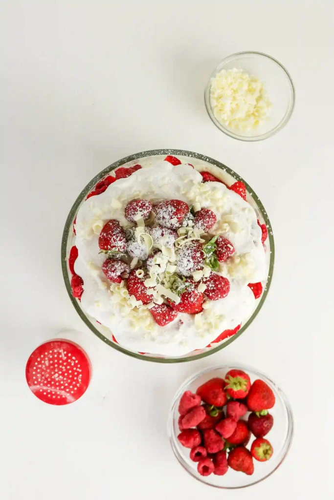 a Christmas trifle with strawberries and whipped cream on top