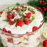 a Christmas trifle with strawberries and whipped cream on top