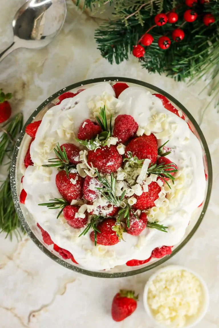 a Christmas trifle with strawberries and whipped cream on top