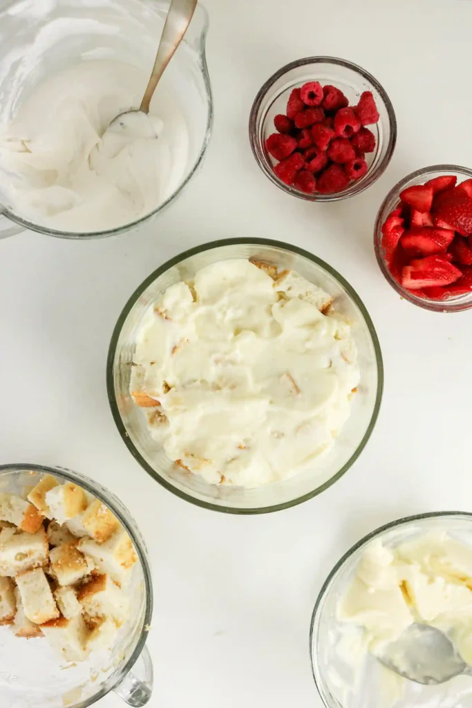 white cake cubes and white chocolate pudding mix in a trifle bowl