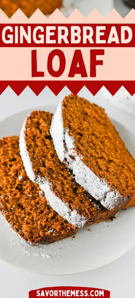 a gingerbread loaf topped with powdered sugar on a white plate.