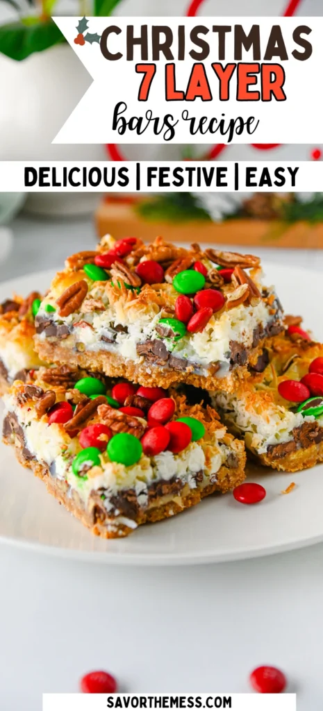 Christmas 7 Layer Bars with green and red m&ms on top on a white plate