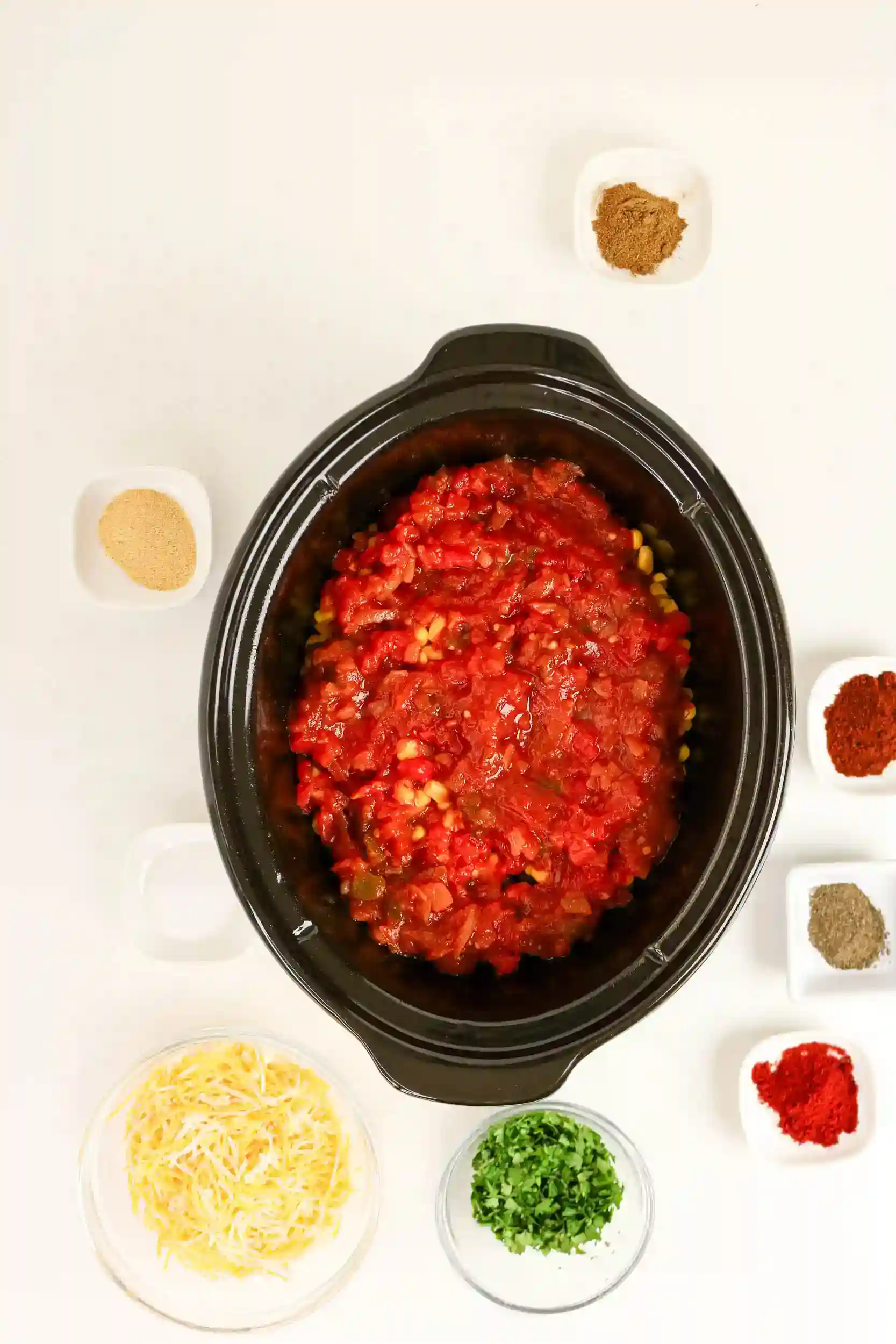 chicken, beans, corn, peppers, and tomatoes in a crockpot