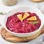 homemade cranberry sauce in a bowl with orange slices