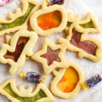 halloween stained glass sugar Cookes on parchment paper