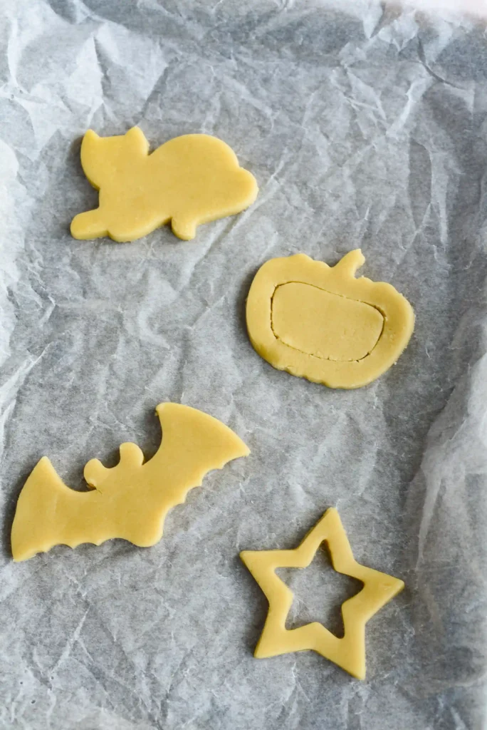 sugar cookie dough cut into halloween shapes