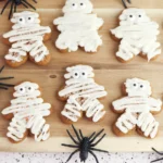 gingerbread cookies with icing on them to look like mummies