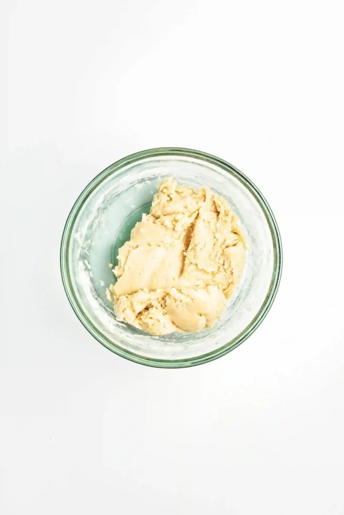 unbaked dough in a glass bowl