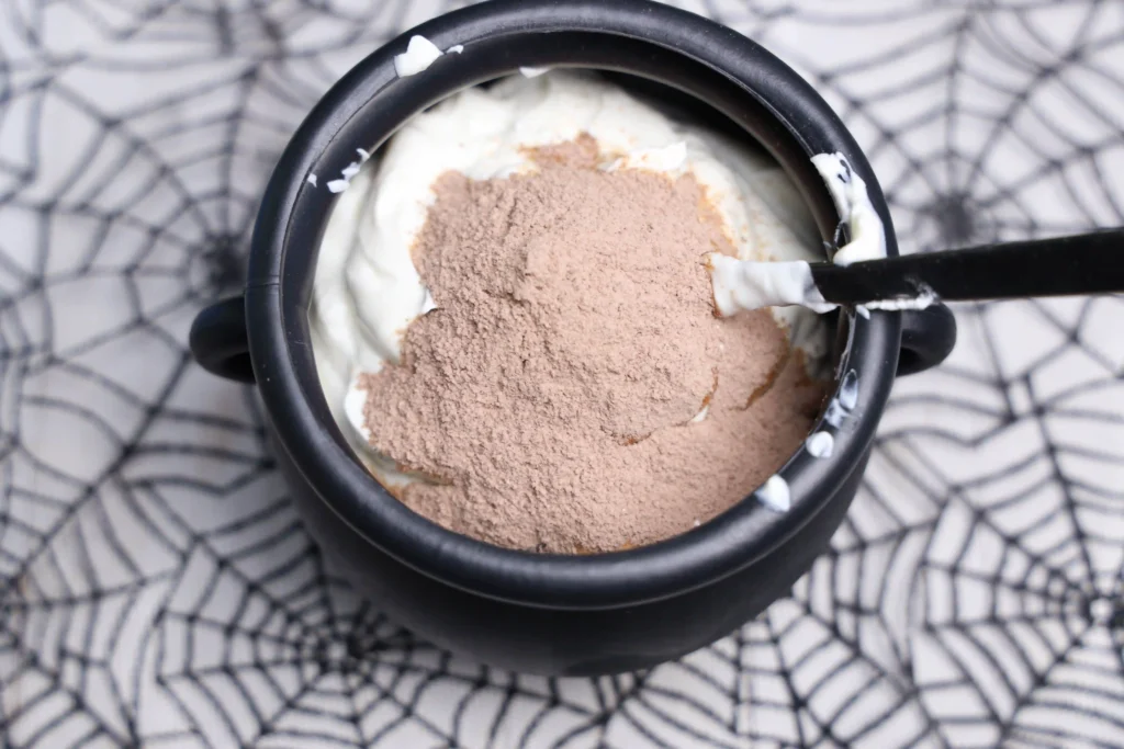 yogurt and chocolate pudding mix in a cauldron