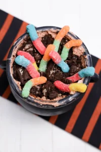 Halloween Dirt Cups in a cauldron and toped with gummy worms