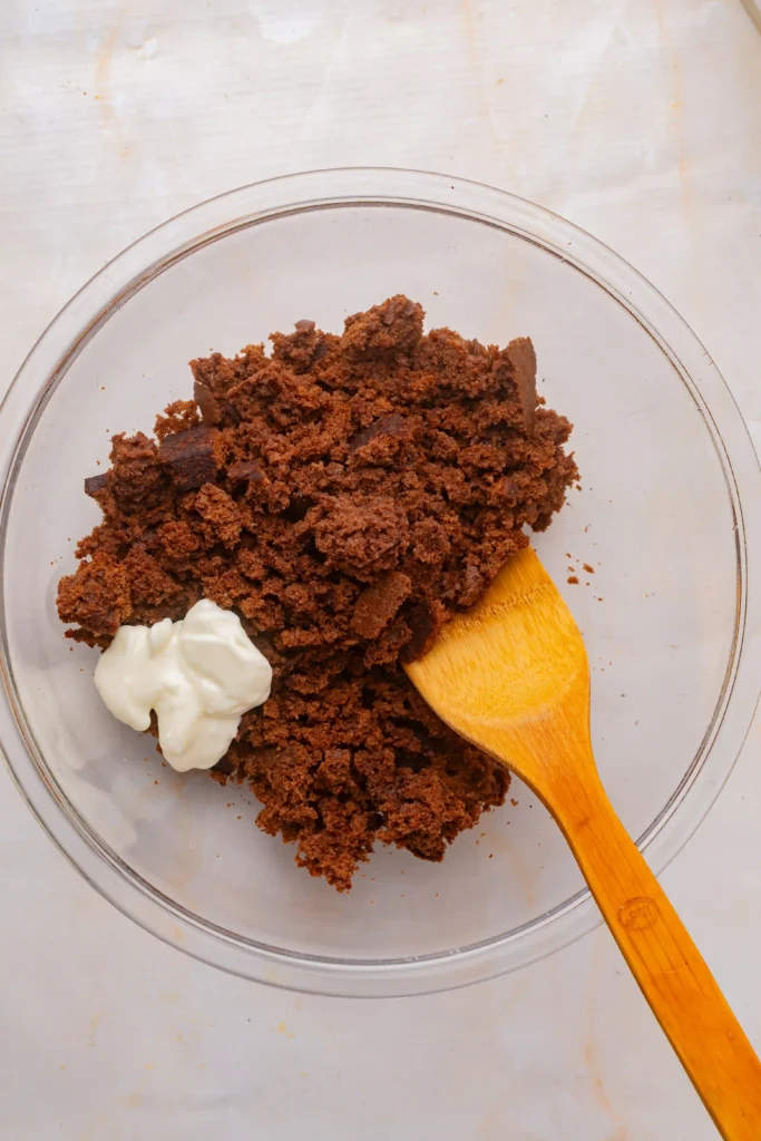 crumbled chocolate cake and cream cheese in a bowl