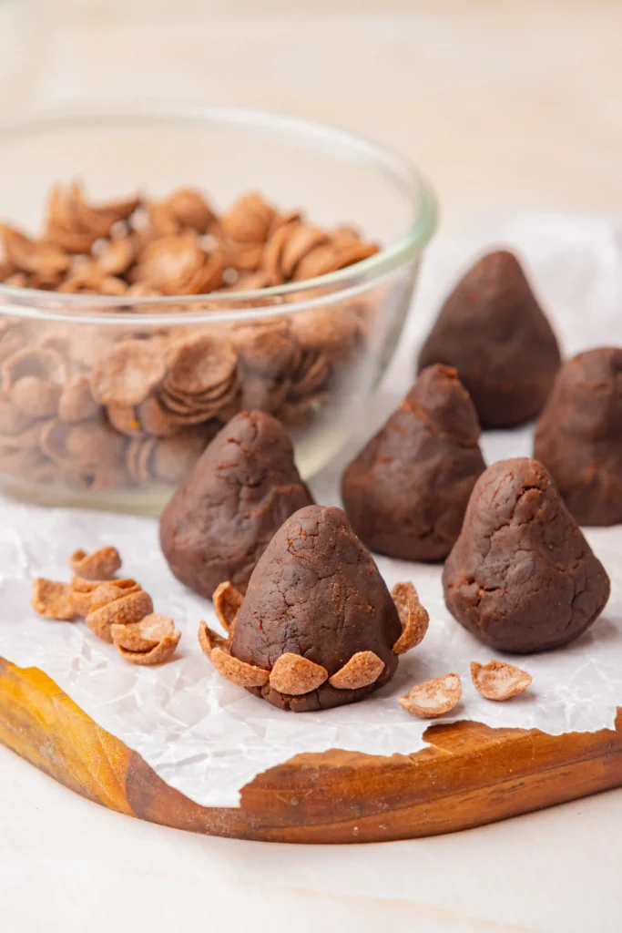 chocolate truffles shaped like a cone with chocolate cereal pressed in