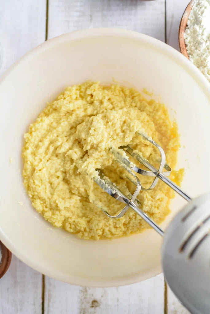 butter and sugar being mixed in a bowl