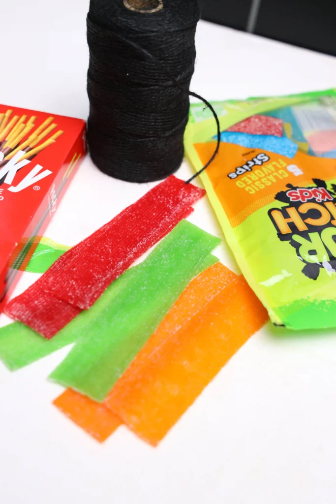 sour patch strips with the ends cut to look like a broom
