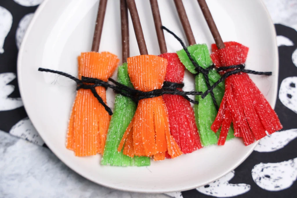 Sour Witch Brooms made of sour patch kid strips and chocolate biscuit sticks