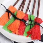 Sour Witch Brooms made of sour patch kid strips and chocolate biscuit sticks
