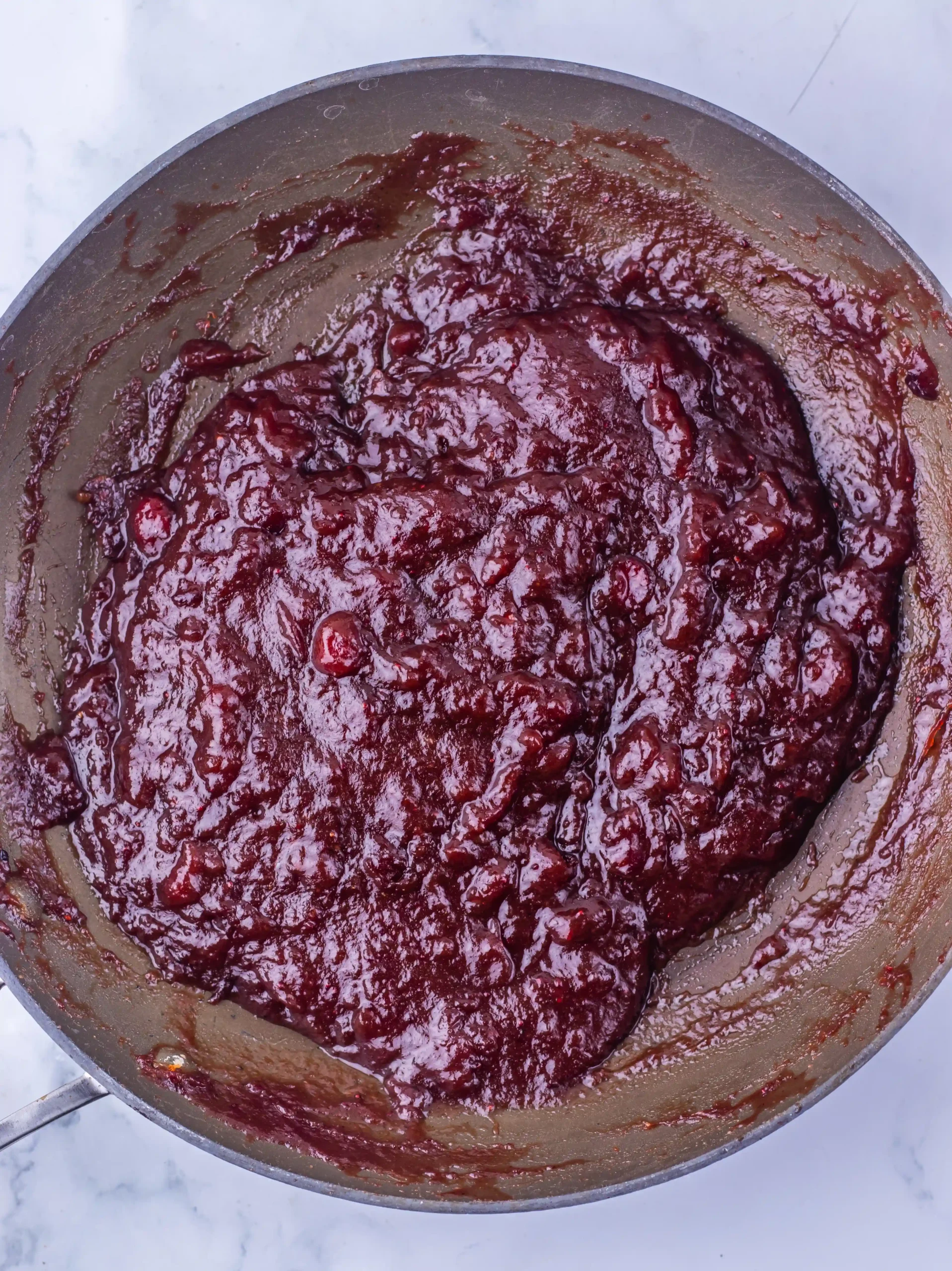 a cranberry sauce glaze in a pan