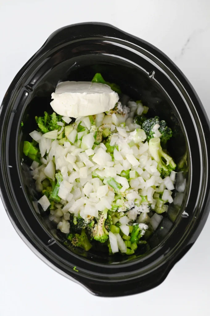 a crockpot with broccoli and spices