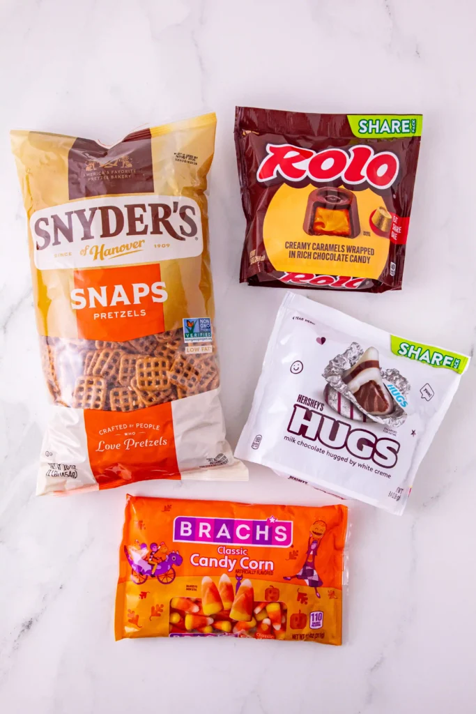 ingredients for the candy corn pretzel bites: pretzel, rolls, Hersheys kisses, and candy corn