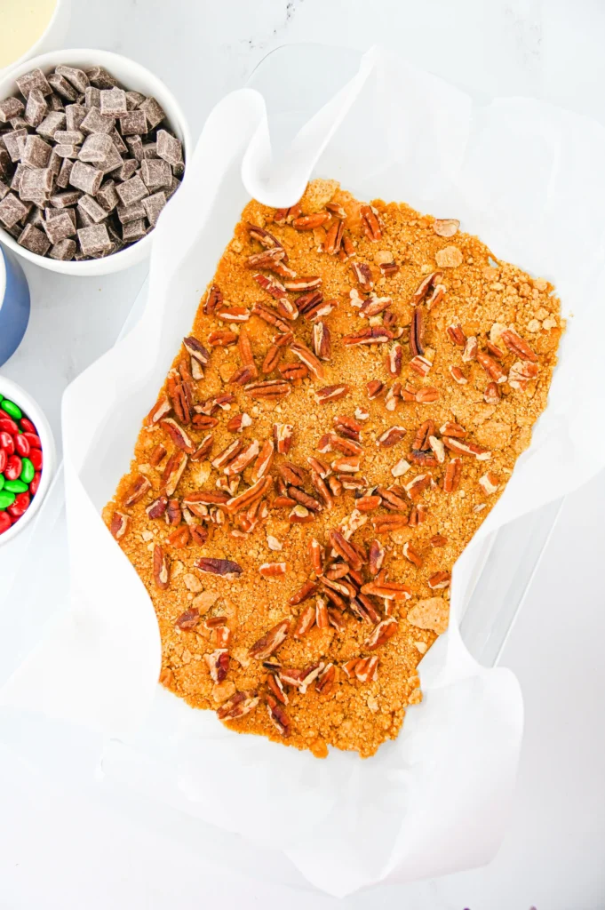 chopped pecans on a graham cracker crust