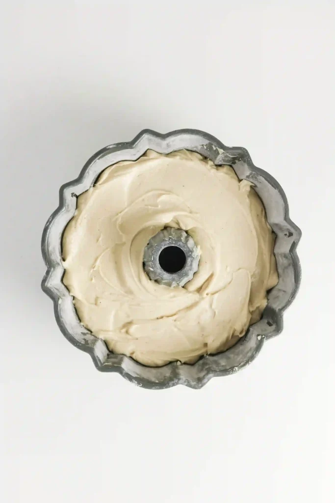 a bundt pan filled with unbaked eggnog pound cake batter