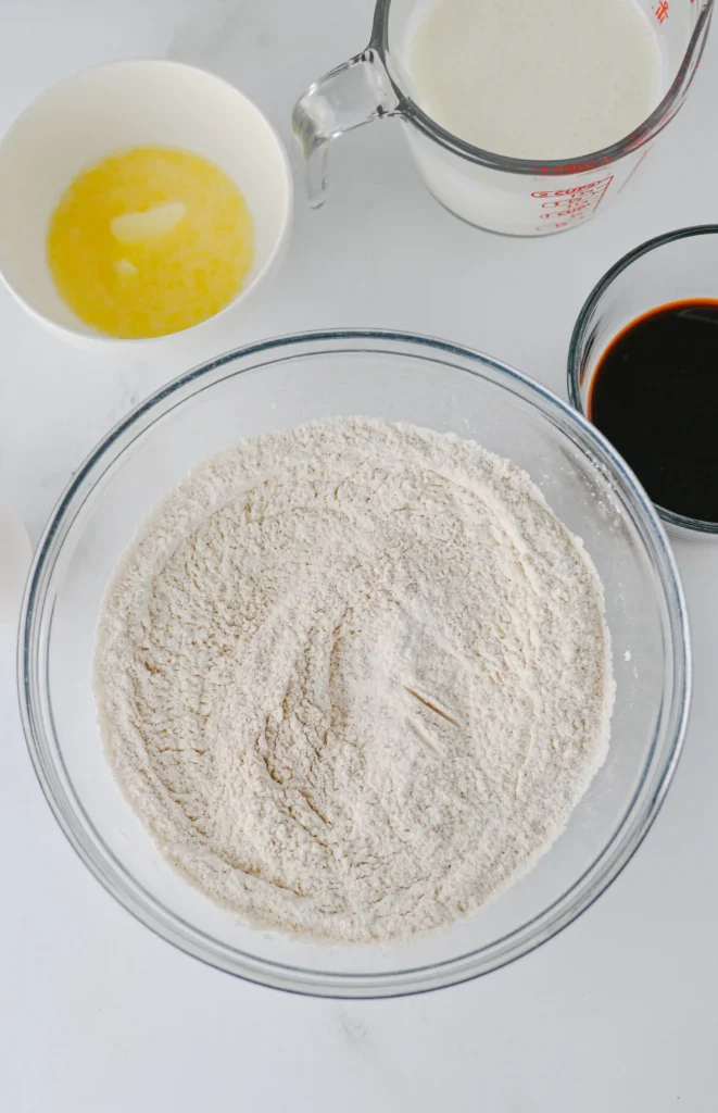 flour, sugar, baking powder, cinnamon, ground ginger, and salt in a glass mixing bowl