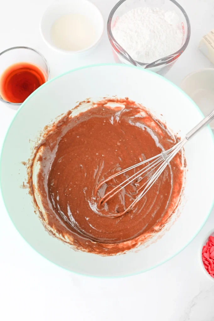 brownie batter in a bowl with a whisk