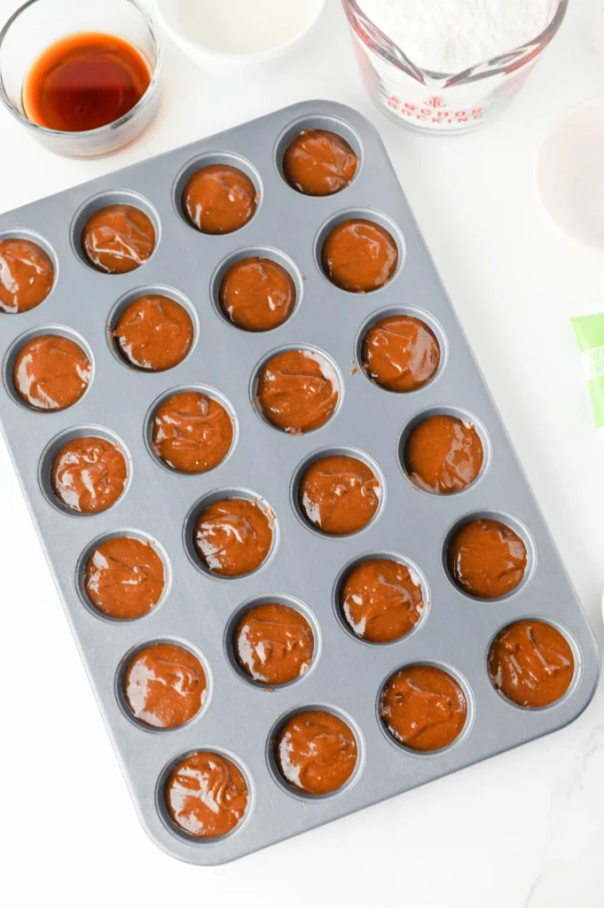 unbaked brownie batter in a mini muffin tin