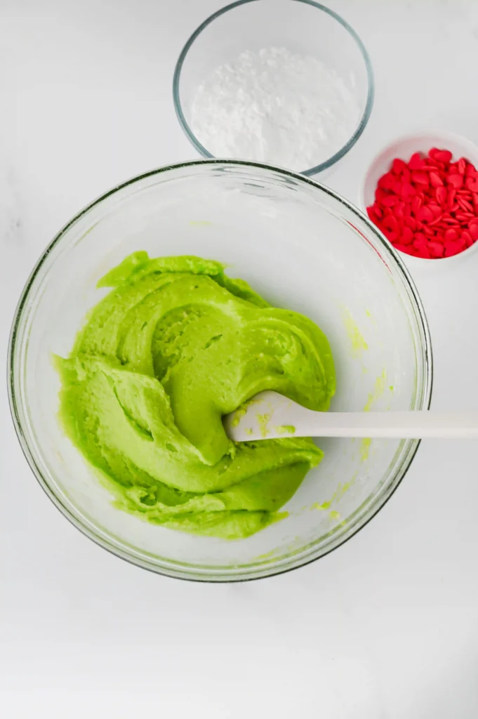 white cake mix, vegetable oil, eggs, and green food coloring mixed in a bowl