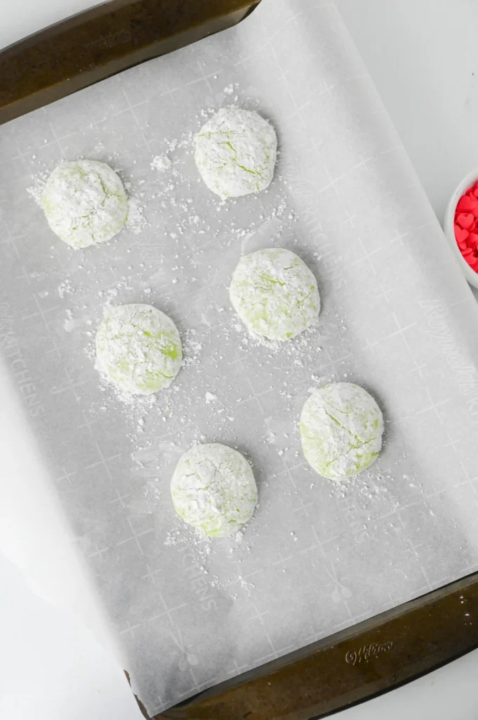 cookies covered in powdered sugar on a baking tray