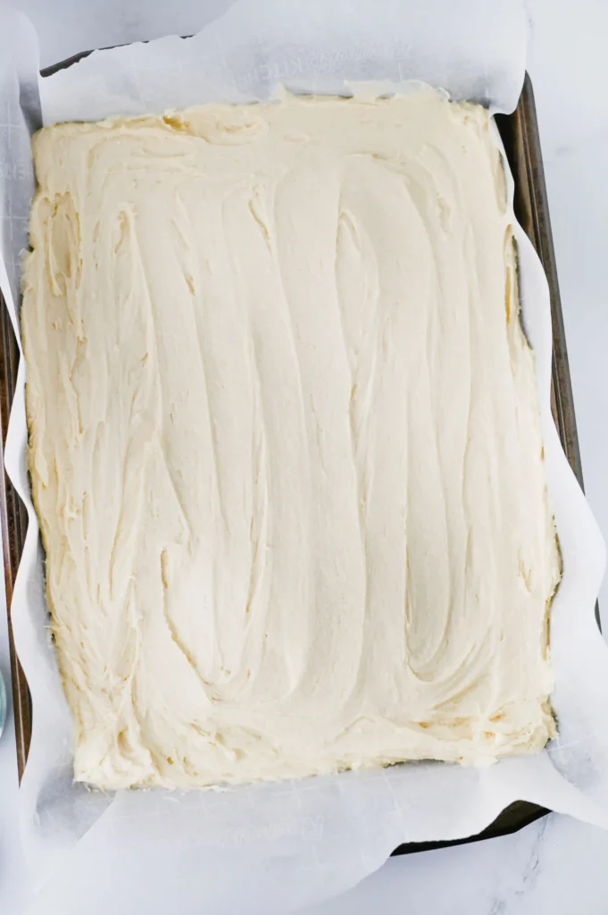sugar cookie batter spread on a baking sheet