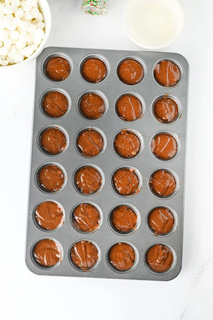 unbaked brownie batter in a mini muffin tin
