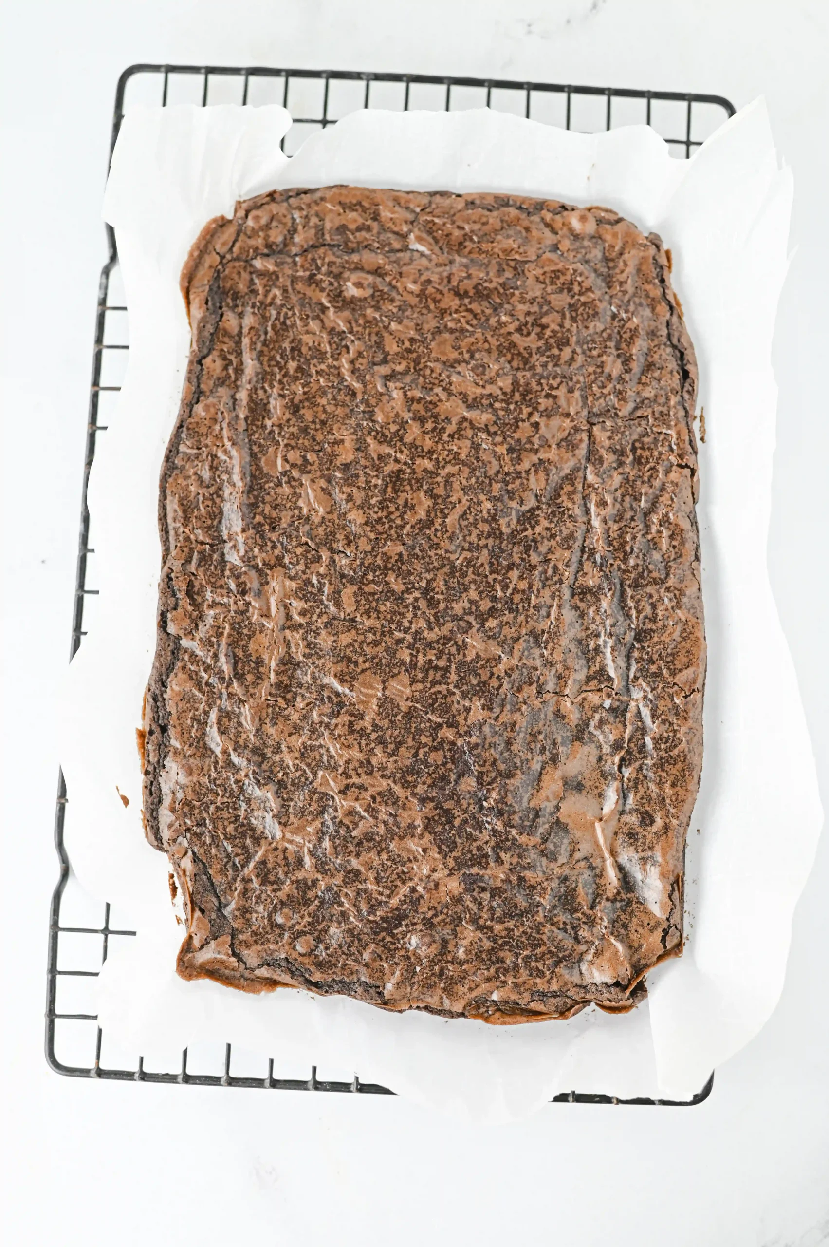 brownies in a baking pan with parchment paper