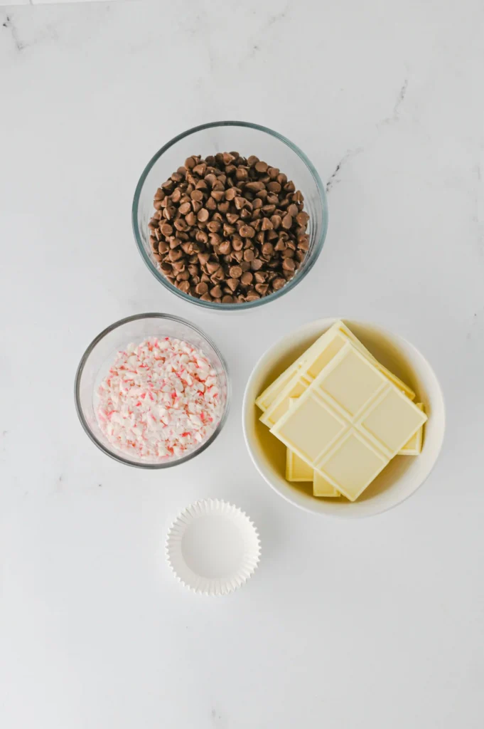 ingredients for the peppermint bark cups- chocolate chips, white chocolate, and crushed candy canes
