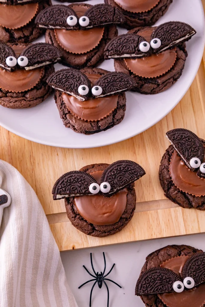reese's and oreos on top of a chocolate cookie to look like a bat