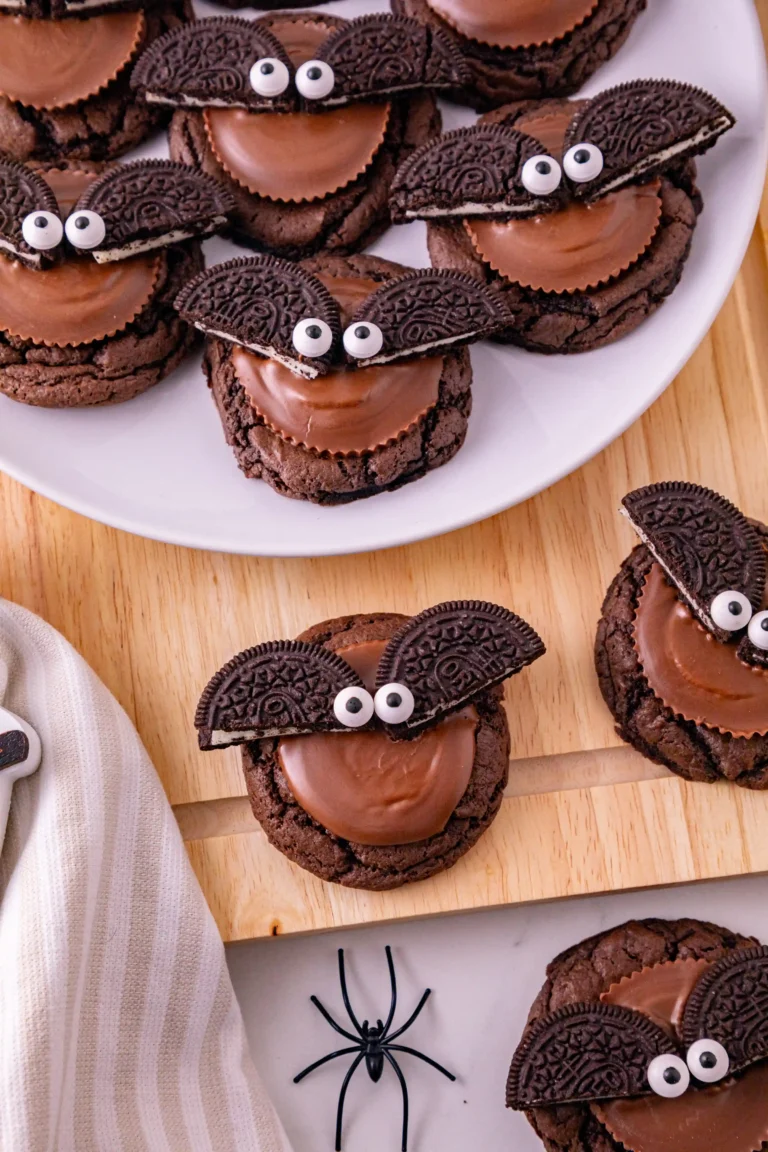 reese's and oreos on top of a chocolate cookie to look like a bat