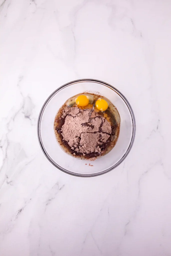 cake mix, oil, and eggs in a glass bowl