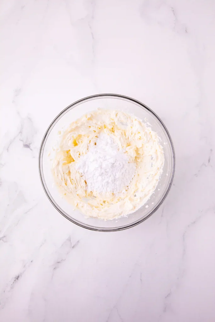powdered sugar in a glass bowl with a cream cheese frosting