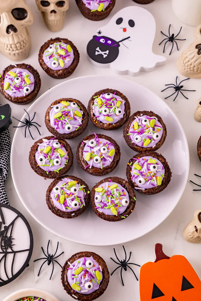 Witch Cauldron Brownies of brownies with purple icing and halloween sprinkles