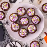 Witch Cauldron Brownies of brownies with purple icing and halloween sprinkles