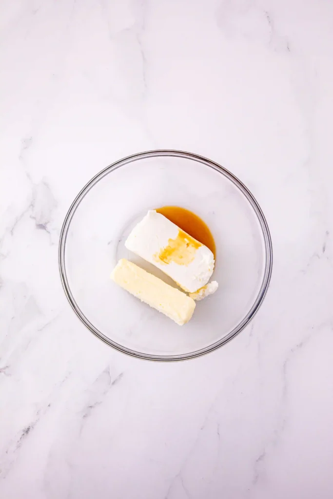 butter, cream cheese, and vanilla extract in a glass bowl