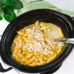 a crockpot with chicken Alfredo in it